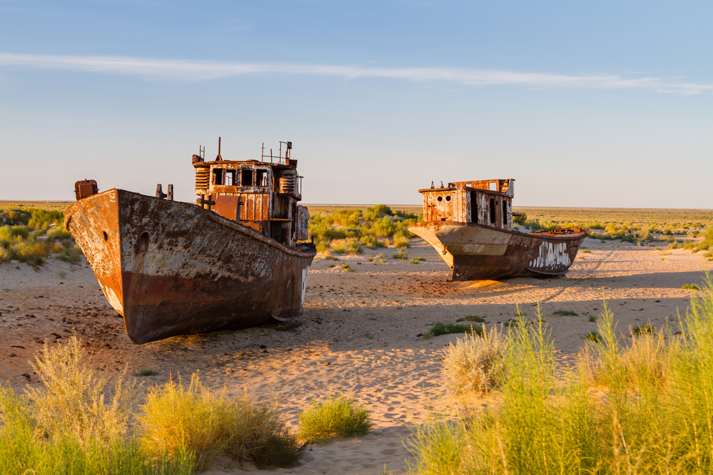 The dry aral sea with 2 rusted ships