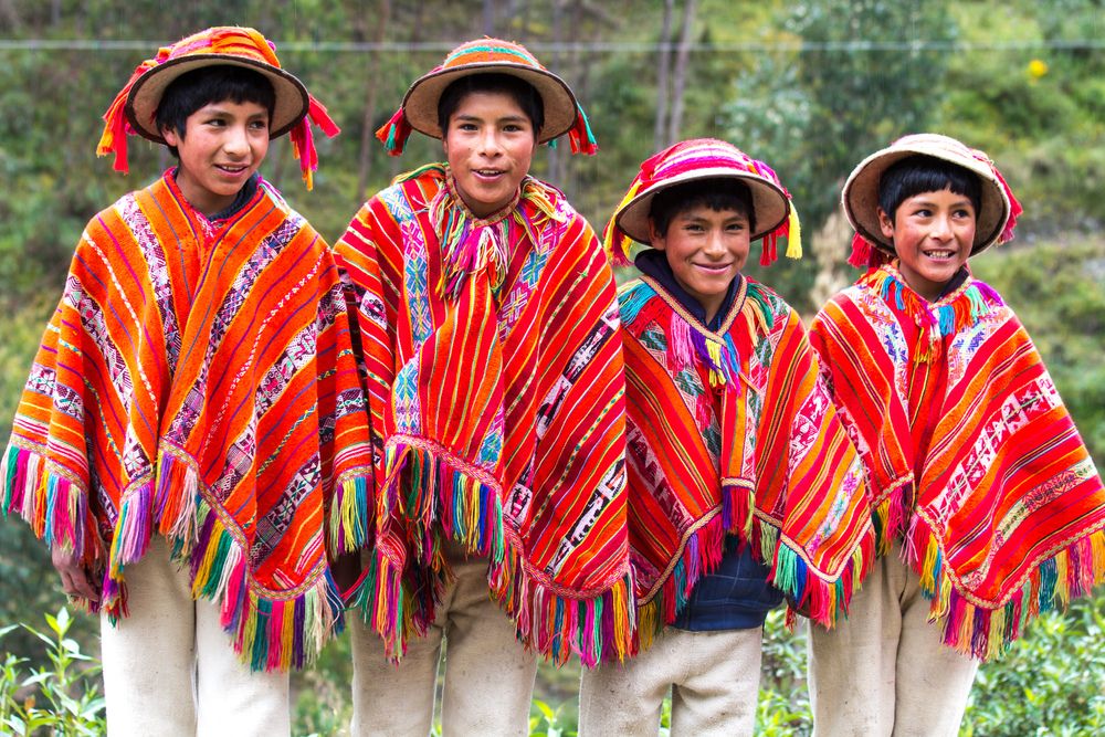4 children wearing Peruvian Ponchos