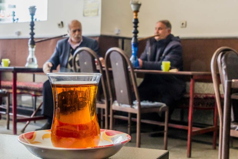 2 men drinking tea in Iranian cafe